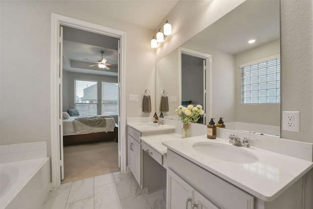 bathroom featuring vanity, plenty of natural light, a bathing tub, and ceiling fan