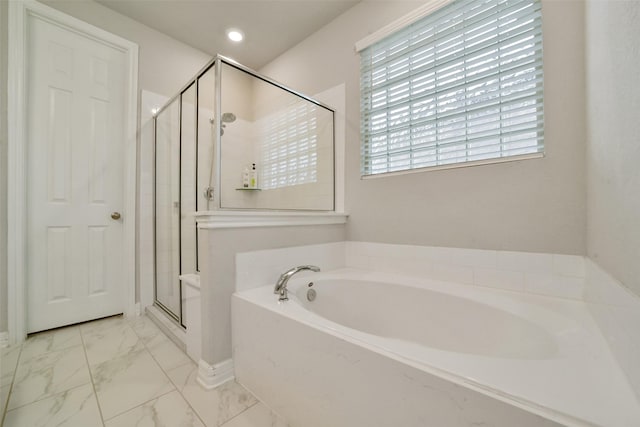 bathroom featuring shower with separate bathtub