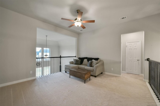 sitting room featuring light colored carpet, vaulted ceiling, and ceiling fan