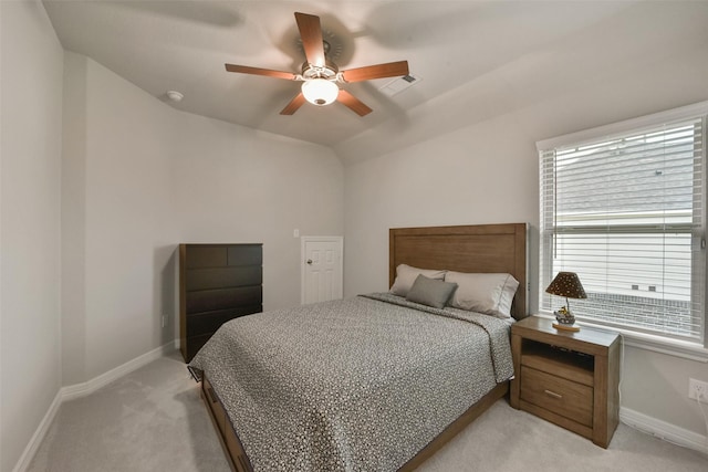 carpeted bedroom with vaulted ceiling and ceiling fan