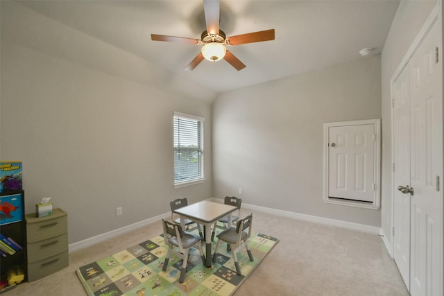 rec room with ceiling fan, light colored carpet, and vaulted ceiling