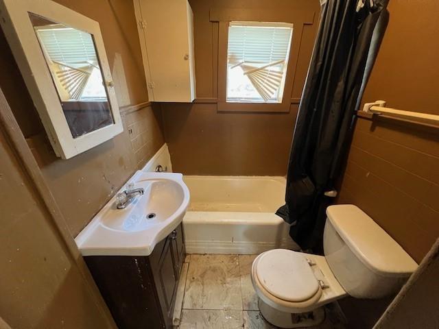 bathroom featuring tile walls, vanity, and toilet