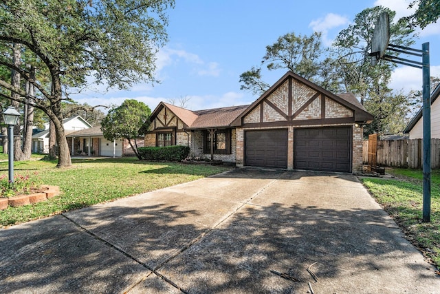 english style home featuring a front yard and a garage