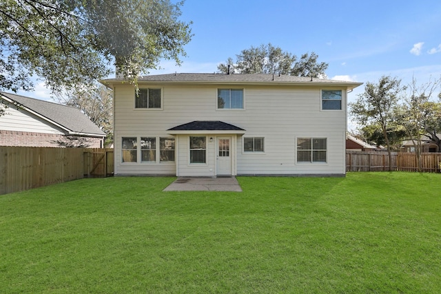 rear view of house featuring a patio area and a yard