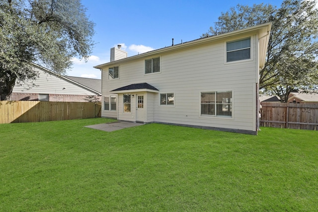 back of house featuring a yard