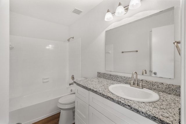 full bathroom featuring hardwood / wood-style floors, vanity, toilet, and shower / tub combination