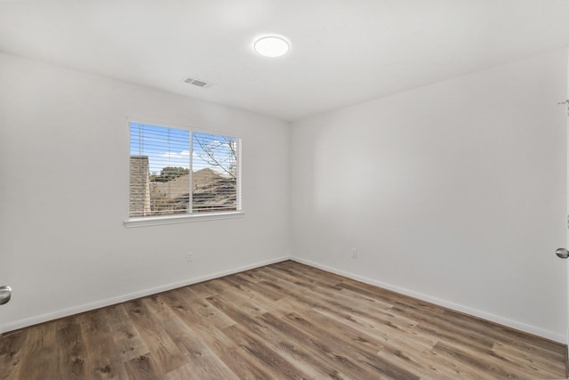 empty room with hardwood / wood-style flooring