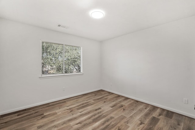 unfurnished room featuring dark hardwood / wood-style flooring