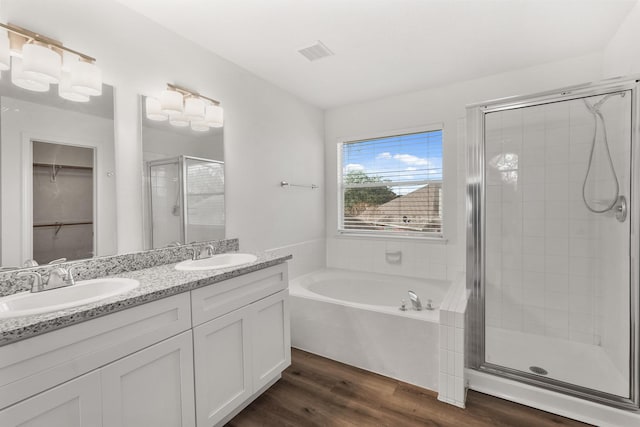 bathroom featuring wood-type flooring, vanity, and independent shower and bath