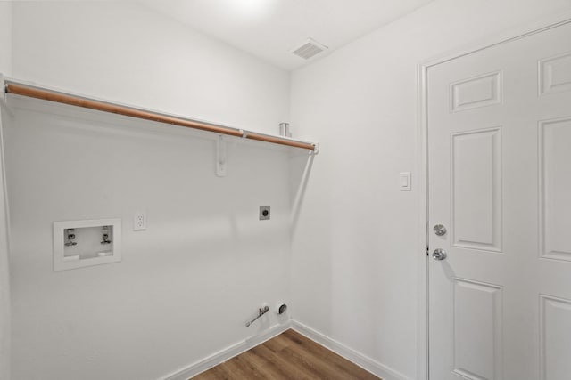 laundry area with electric dryer hookup, dark hardwood / wood-style flooring, hookup for a gas dryer, and hookup for a washing machine