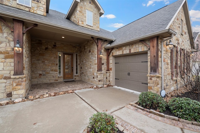 view of front of house with a garage, stone siding, driveway, and roof with shingles