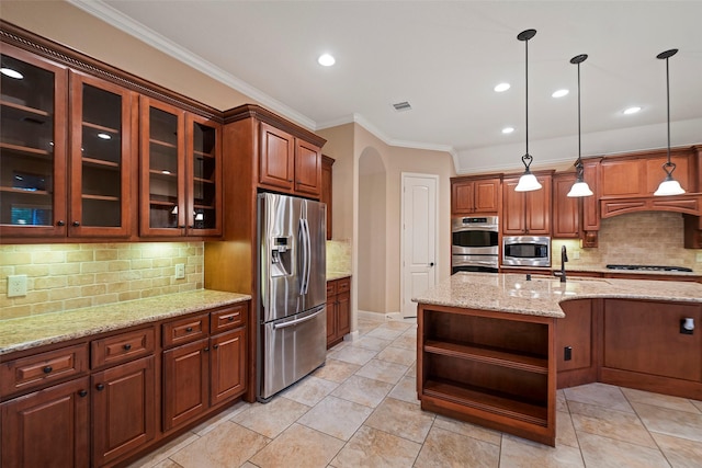 kitchen with pendant lighting, stainless steel appliances, light stone counters, and backsplash