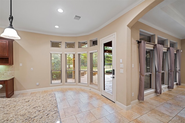 entryway featuring ornamental molding, arched walkways, and visible vents