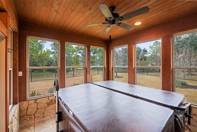 sunroom featuring ceiling fan