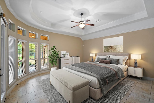 bedroom featuring light tile patterned floors, visible vents, baseboards, a tray ceiling, and crown molding