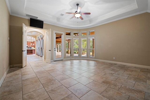 unfurnished room featuring ceiling fan, ornamental molding, and a tray ceiling