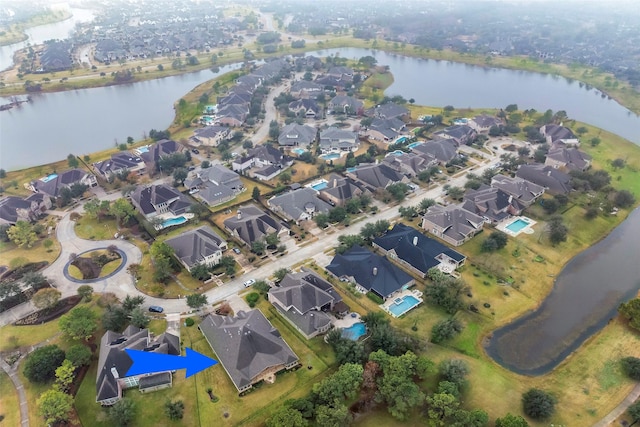 bird's eye view featuring a water view and a residential view