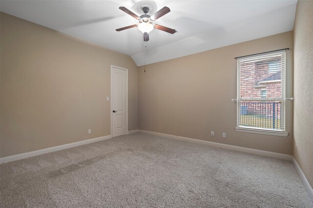 unfurnished room with ceiling fan, carpet floors, and vaulted ceiling