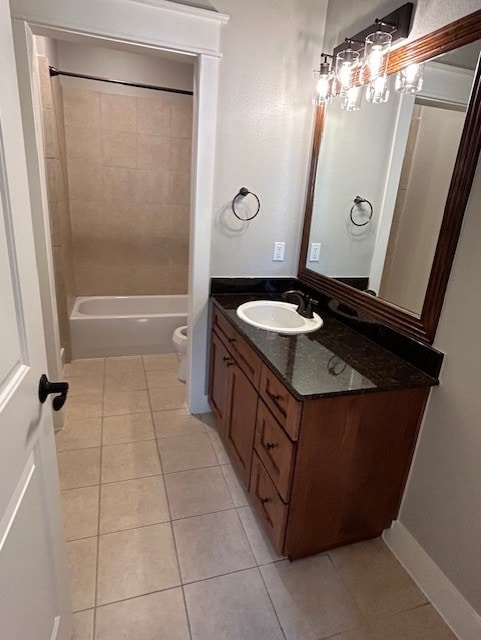 full bathroom with toilet, vanity, tile patterned floors, and tiled shower / bath