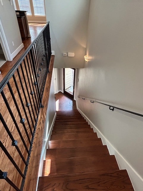 stairs with hardwood / wood-style flooring and a wealth of natural light