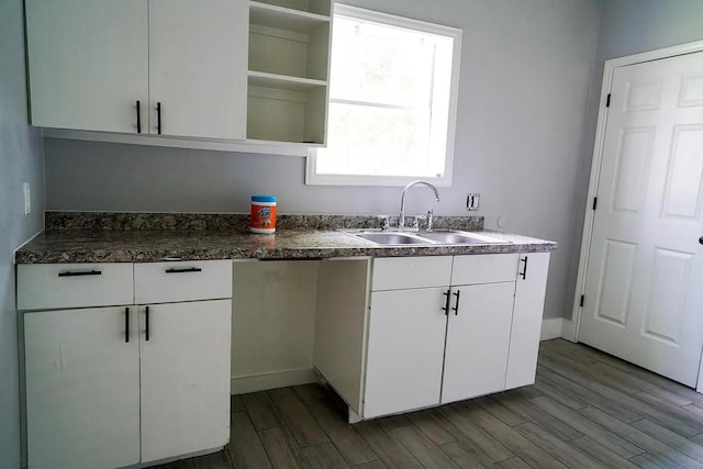 kitchen with white cabinetry and sink