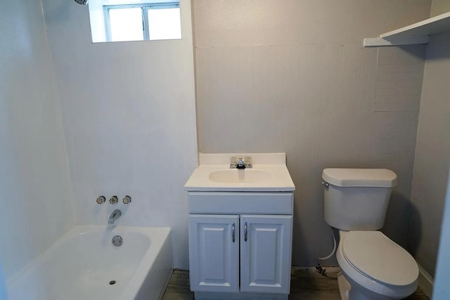 bathroom with a tub to relax in, vanity, and toilet