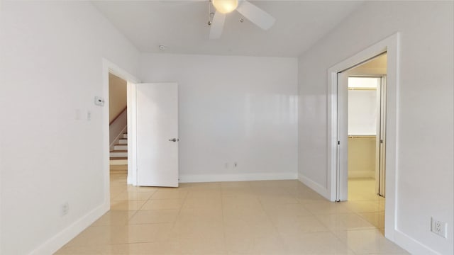 empty room featuring light tile patterned floors and ceiling fan