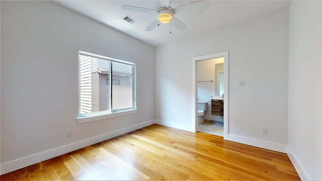 spare room featuring ceiling fan, a healthy amount of sunlight, and light hardwood / wood-style floors