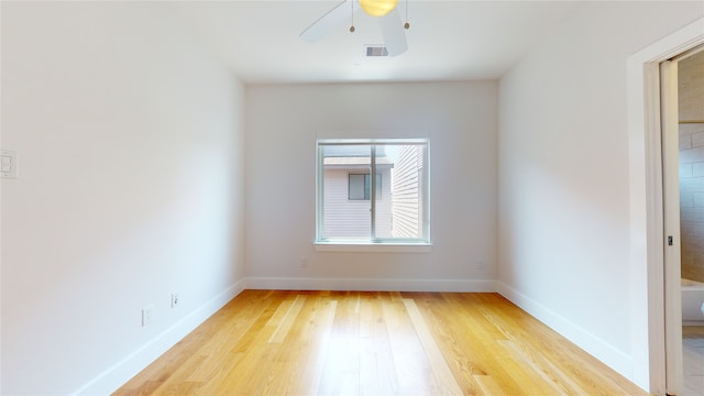 unfurnished room with ceiling fan and light wood-type flooring