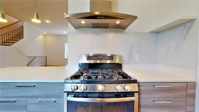 kitchen with island range hood, decorative light fixtures, and stainless steel gas range oven