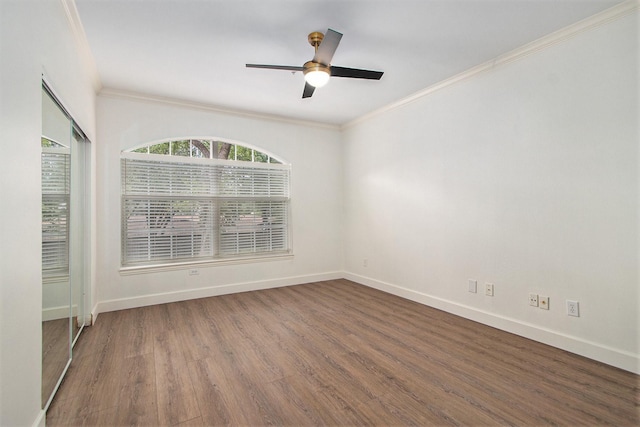 unfurnished room featuring ceiling fan, dark wood-type flooring, and ornamental molding