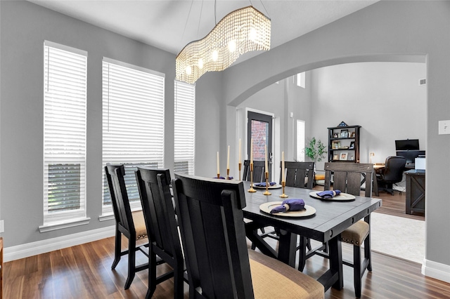 dining room with a notable chandelier and dark hardwood / wood-style flooring