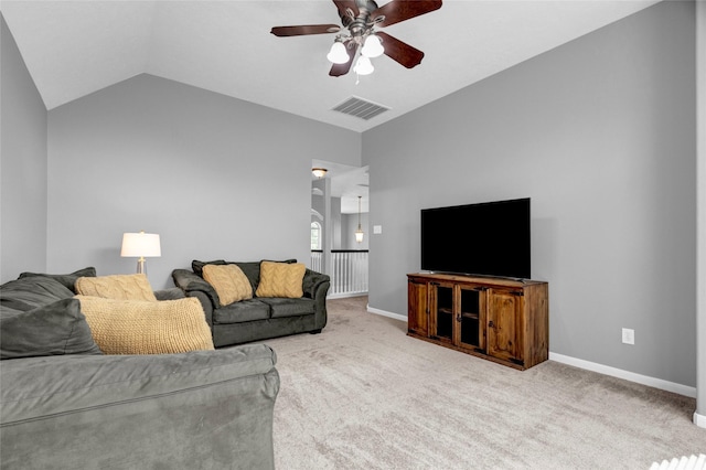 living room with ceiling fan, carpet floors, and lofted ceiling