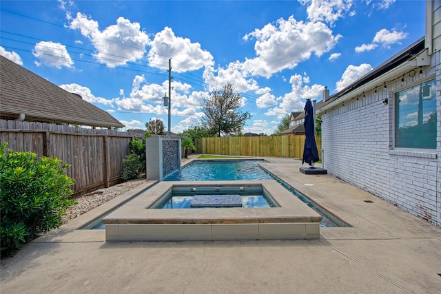 view of pool featuring an in ground hot tub