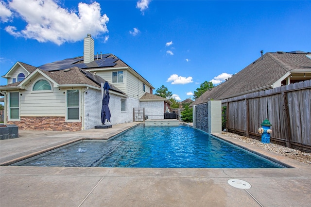 view of swimming pool featuring pool water feature and a patio