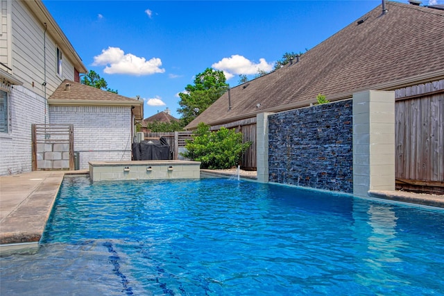 view of swimming pool featuring pool water feature