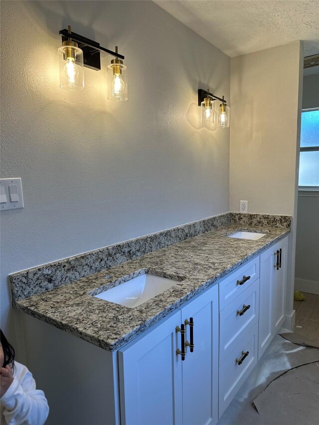 bathroom featuring a textured ceiling and vanity