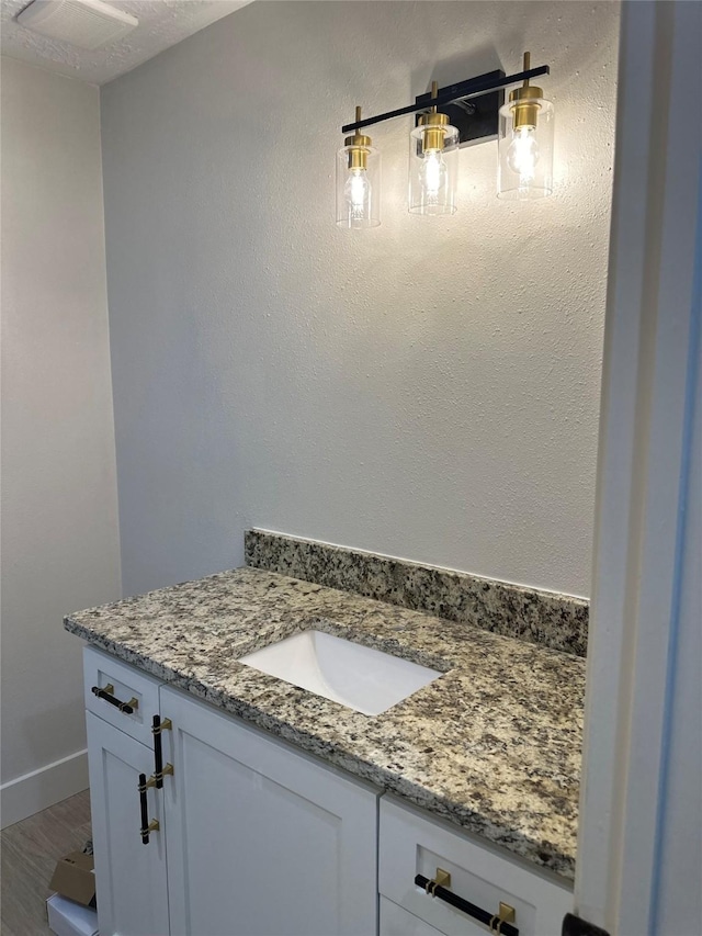 bathroom with vanity and hardwood / wood-style flooring