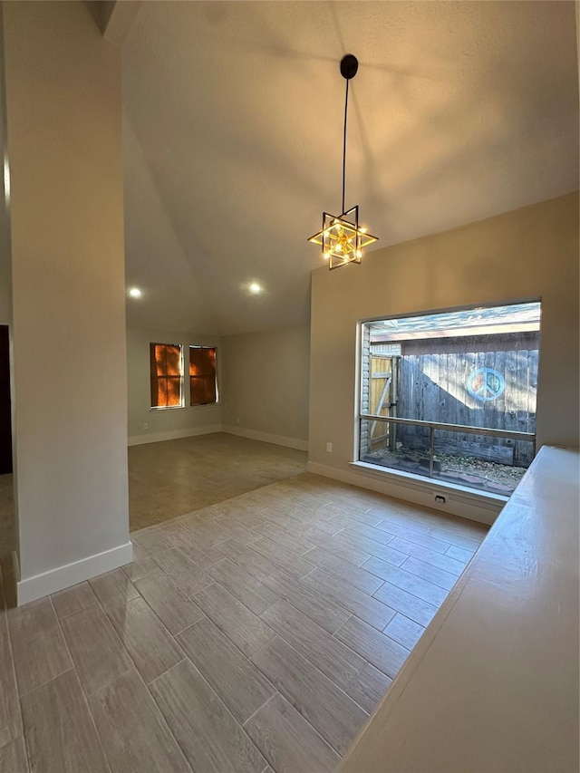 unfurnished living room featuring a notable chandelier