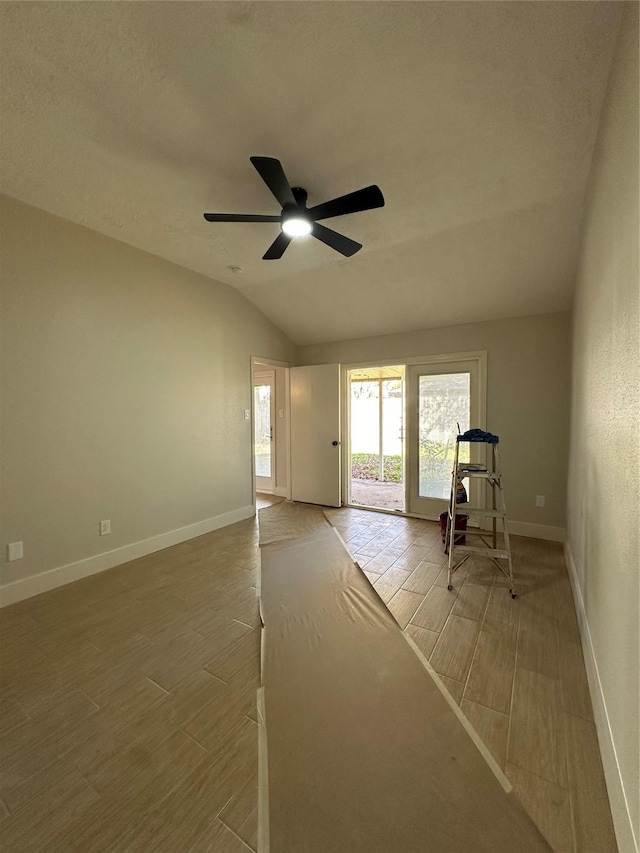 spare room with ceiling fan and lofted ceiling