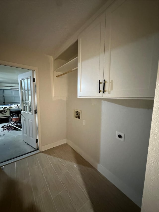 washroom featuring washer hookup, electric dryer hookup, and cabinets