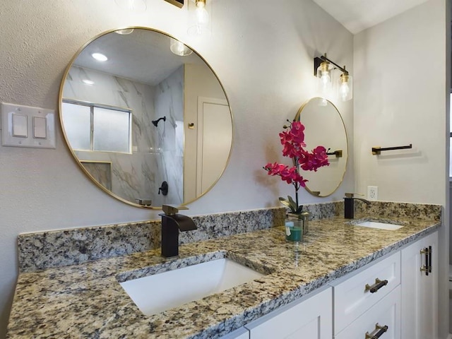 bathroom with vanity and a shower