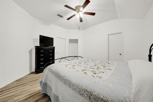 bedroom with ceiling fan, wood-type flooring, and vaulted ceiling