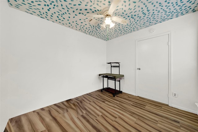 empty room featuring ceiling fan and hardwood / wood-style flooring