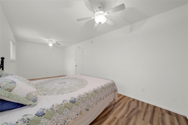 bedroom with light hardwood / wood-style flooring and ceiling fan