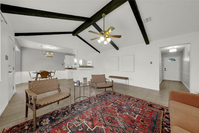 tiled living room with lofted ceiling with beams and ceiling fan with notable chandelier