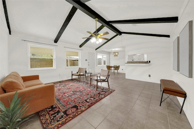 living room featuring tile patterned flooring, vaulted ceiling with beams, ceiling fan, and plenty of natural light