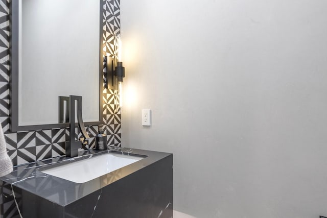 bathroom with vanity and tasteful backsplash