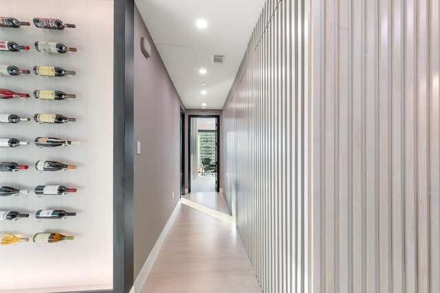 hallway with light hardwood / wood-style floors