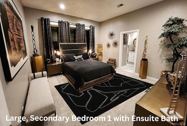 carpeted bedroom featuring ensuite bathroom